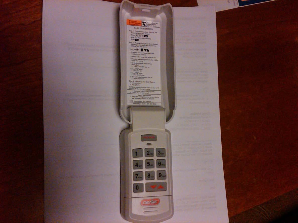 Wall mounted wireless remote control transmitter for operation of garage door opener - FCC ID B8Q315390KP - The Genie Company a Division of Overhead Door Corporation (2)