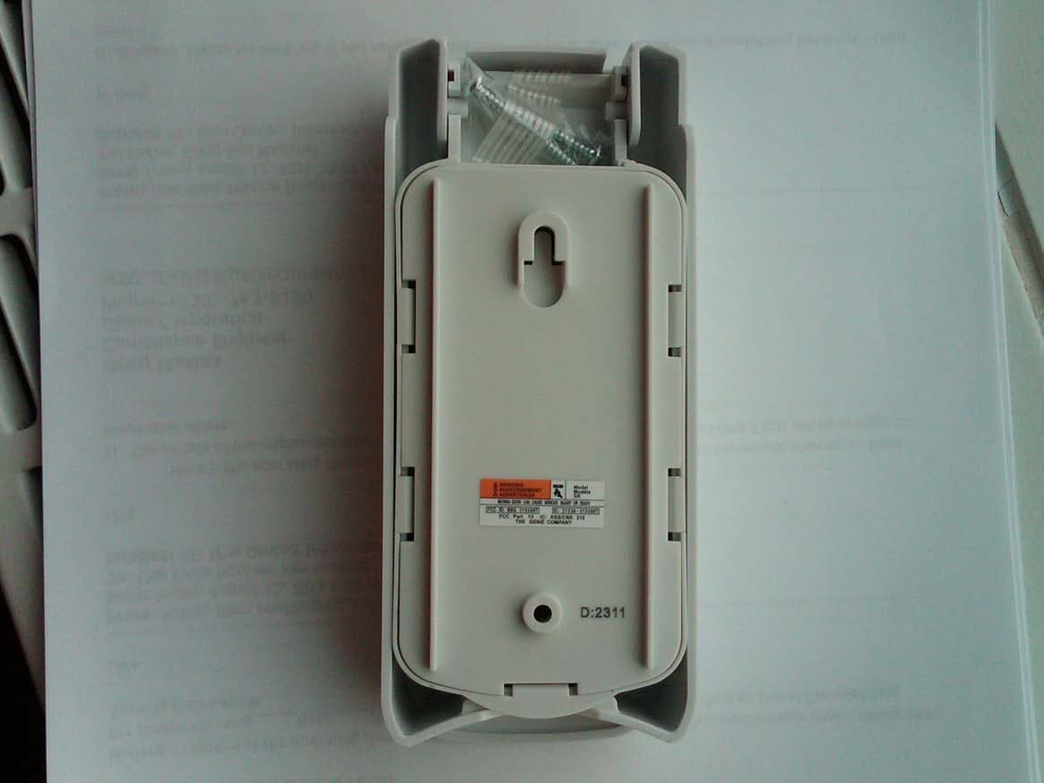 Wall mounted wireless remote control transmitter for operation of garage door opener - FCC ID B8Q315390KP - The Genie Company a Division of Overhead Door Corporation (4)