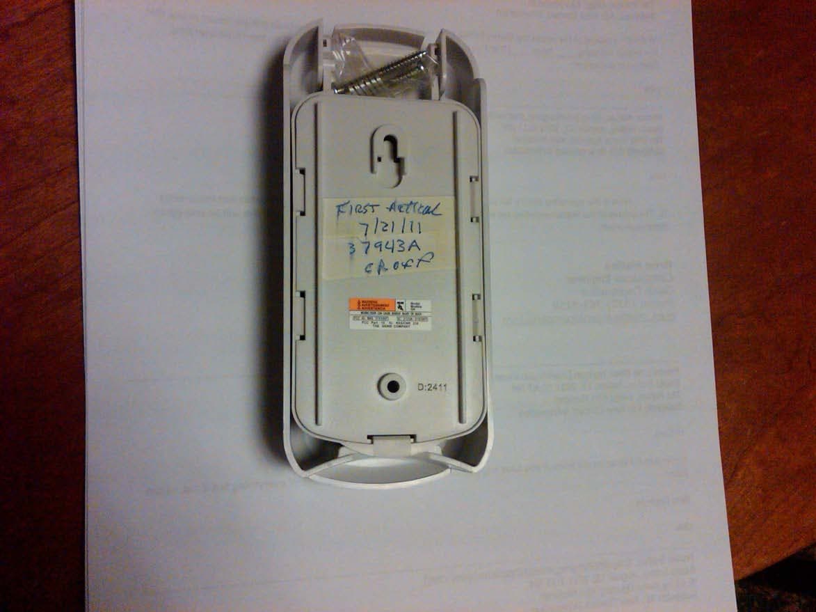 Wall mounted wireless remote control transmitter for operation of garage door opener - FCC ID B8Q315390KP - The Genie Company a Division of Overhead Door Corporation